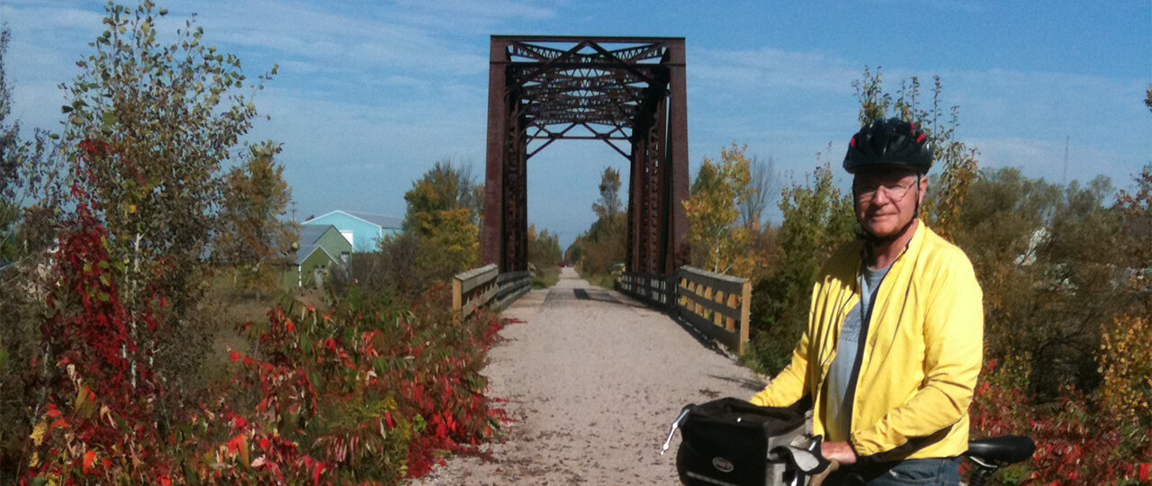 Fall Bike Rider by Train Bridge